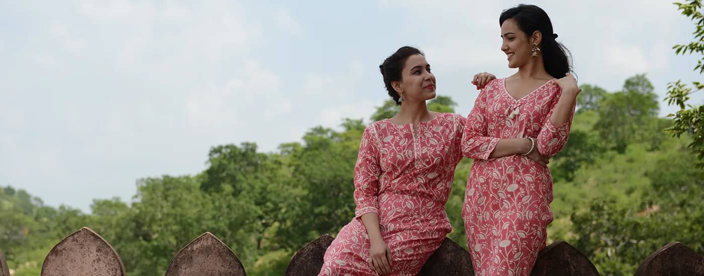 Women in Pink Traditional Ethnic Wear at Historic Fort Setting